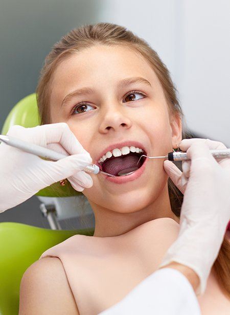 Young girl receiving children's dentistry treatment