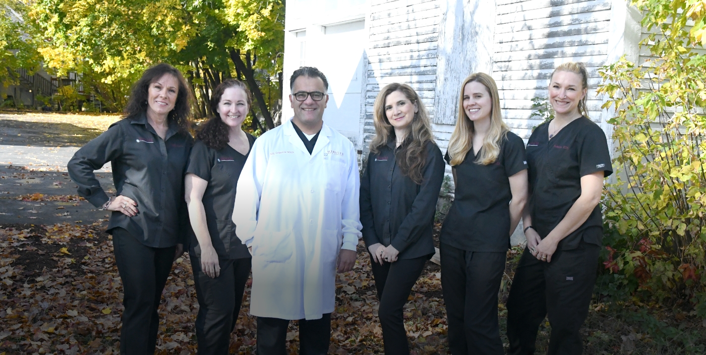 Webster Dental Associates of Manchester dentist and team members smiling outdoors