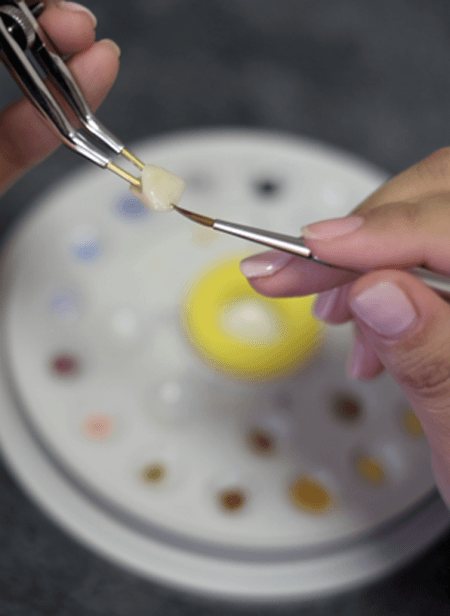 A dental technician working on a CEREC dental crown