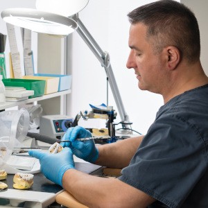 Dental technician working on dentures in Manchester