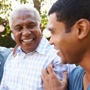 Dentures patient in Manchester smiling with friends