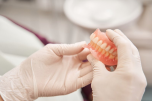 Dentist checking on a pair of dentures