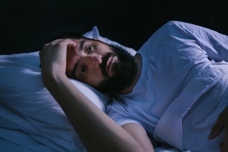 man having trouble falling asleep